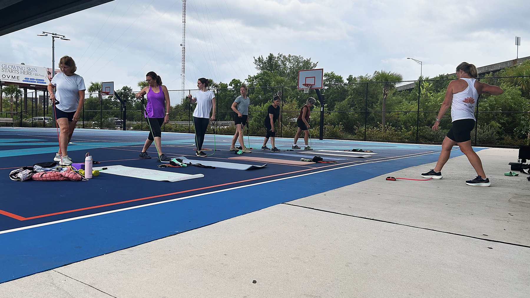Kim walking the line during a Wednesday class, the group working with resistance bands
